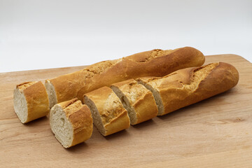French Baguette bread on wooden cutting board.
