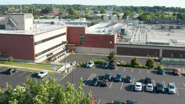 Aerial of employer workplace. Office, manufacturing factory, plant and facility headquarters.