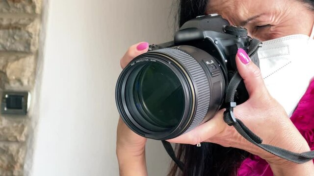 Female photographer taking images of house interior detail with long lens