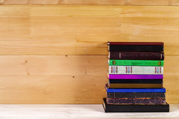 Stack of old books on a wooden shelf