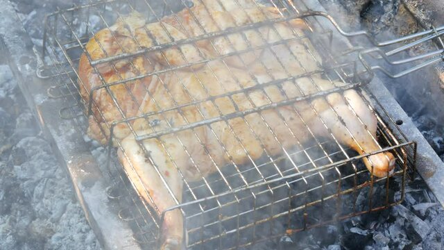 Whole juicy with spices grilled chicken tabaka or tapaka at summer picnic