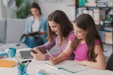 Happy students doing homework together
