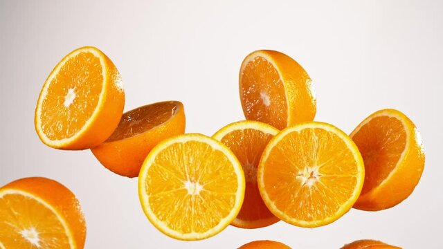 Super Slow Motion Shot of Flying Fresh Orange Cuts at 1000 fps.