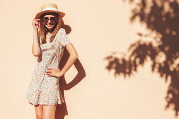 Young beautiful smiling hipster woman in trendy summer sundress. Sexy carefree woman posing in the...