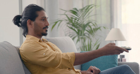 Man sitting on the couch and watching TV