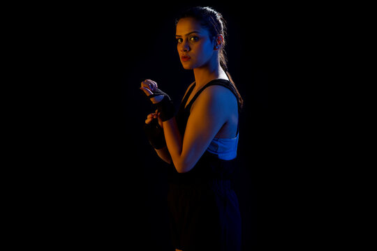 A WOMAN WRESTLER LOOKING AT CAMERA WHILE GETTING READY FOR PRACTISE