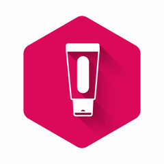 White Tube of hand cream icon isolated with long shadow background. Pink hexagon button. Vector