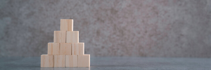 Close-Up Of Wooden Toy Blocks On Table Against Wall with copy space