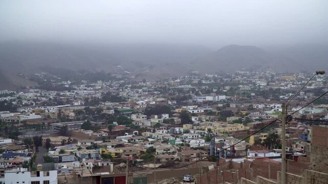 Scenic Viewpoint Overlooking City of Sol La Molina in LIma, Peru with Fog Over Mountains in the Background. Slow Zoom.