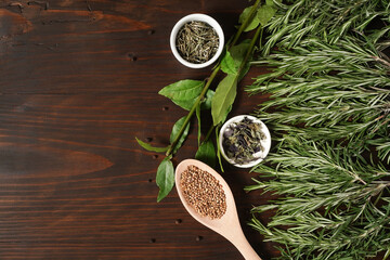 Fresh herbs and spices on wooden table. Top view with copy space for text. Fresh organic green fragrant herbs. Aromatic ingredients for cooking. Healthy concept