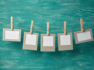 paper cards hanging on a rope on a wooden background