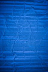 Crumpled blue cardboard texture.