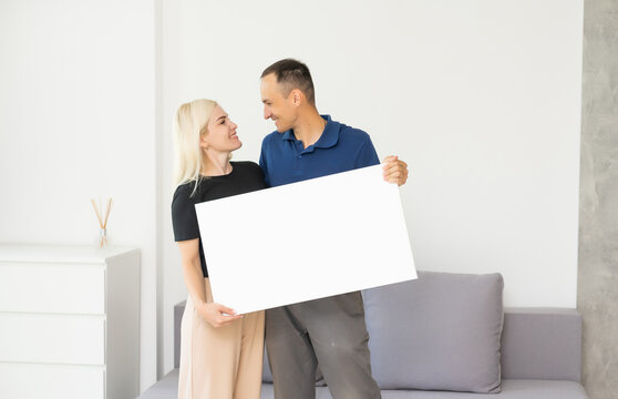 stylish couple holding a photo canvas