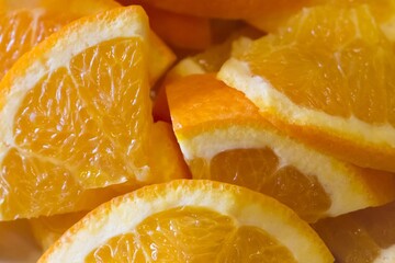 Delicious succulent orange fruit slices with healthy vitamins. Many orange pieces with skin and pulp waiting for e.g. tasty summer party cocktails - 448508116