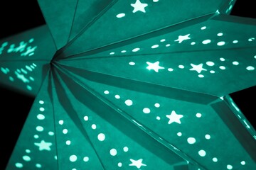 Colorful turquoise xmas lantern star at christmas market season. Beautiful shiny star mood lamp is...