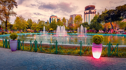 Spectacular spring view of Scanderbeg Square with illuminated fountain. Picturesque sunset in capital of Albania - Tirana. Traveling concept background. - obrazy, fototapety, plakaty