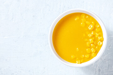 Sweet corn cream soup, overhead shot with copy space. Vegan chowder for a detox diet