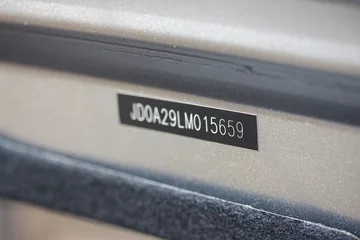 Fotobehang Vehicle identification number (VIN) plate on a new car  © hanjosan
