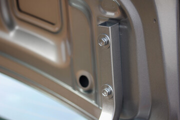Close up of an exposed trunk lid hinge