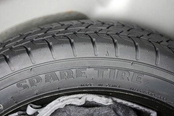 Close up of a spare tire in the trunk of a new vehicle