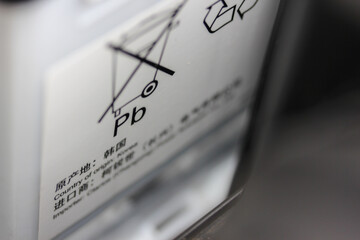 close up of a lead (Pb) acid battery warning label