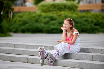 cute little girl on roller skates at park.