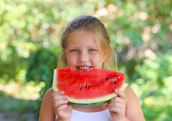 Cute child girl eats watermelon. Selective focus.