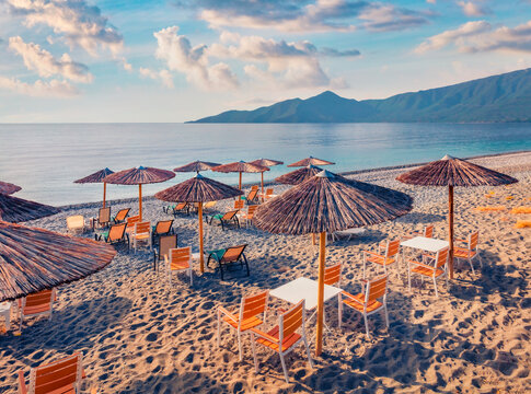 Small restaurant on Plakas beach, Leonidio town location. Colorful morning seascape of Mediterranean sea. Attractive outdoor scene of Peloponnese peninsula, Greece, Europe.