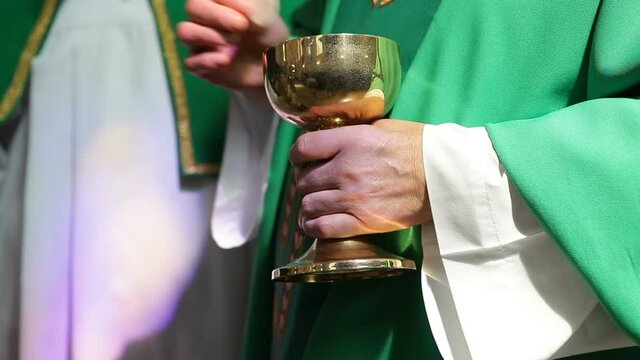 A Catholic priest distributes a prosphora from a bowl to believing parishioners. Liturgical liturgical bread used in Orthodoxy for the sacrament of the Eucharist.priest gives altar breads.
