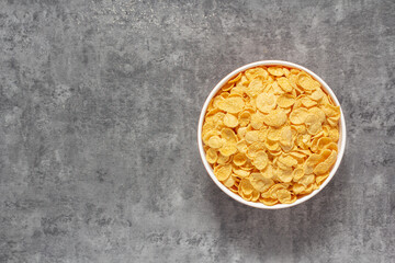 An image top view corn or cereal in the cup is food for healthy breakfast or snack detail processed of dietary grain use for background with copy space for text.