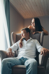 Obraz premium the love of a young husband and wife, happy faces, a date in nature, joy, a guy rides a girl on his back. Love forever Romance young