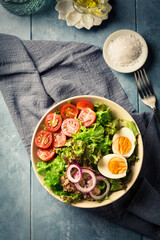 Salad bowl with tuna, egg, tomato and onions
