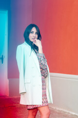 Portrait of a beautiful caucasian dark-haired young woman with blue and red glints