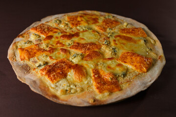Tasty pizza four cheese - parmesan, dour blue, feta, mozzarella