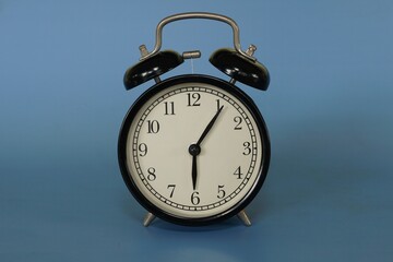 alarm clock isolated on blue background