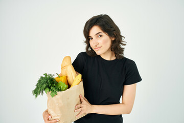 woman in black t-shirt package with groceries healthy food homework