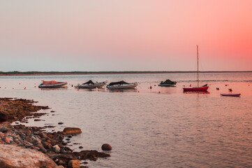 small bay with a beach and boats in the north of Sardinia.Beautiful sunset