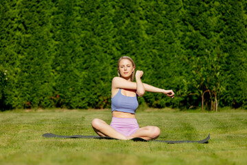 Girl practices yoga in the backyard of her house