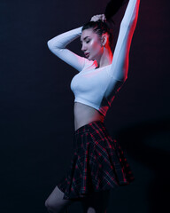 Woman in schoolgirl clothes in neon