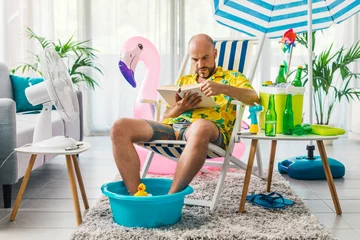 Deurstickers Man spending his vacations at home and reading a book © StockPhotoPro
