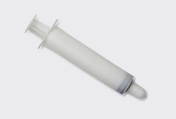White syringe use with sodium chloride for nasal irrigation. Medical equipment on white laboratory table.