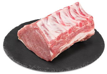 raw pork meat on black round stone plate isolated on white background. Clipping path and full depth of field