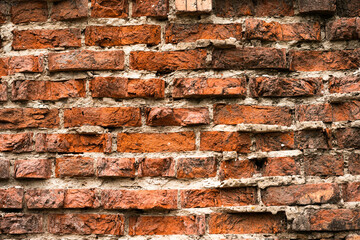 old crumbling red brick wall