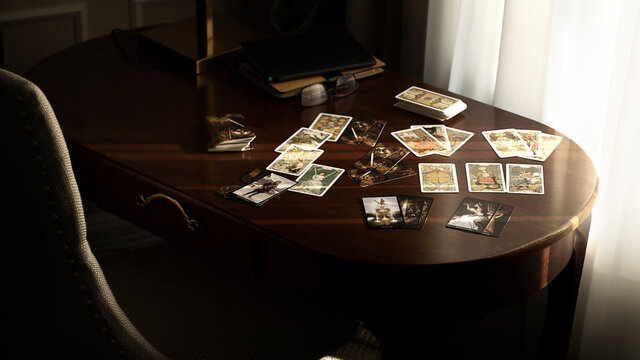 Blurred tarot cards on the table, esoteric concept, fortune telling predictions