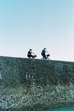 Two gendarmes where patrolling on their bikes in Vendée on a clear and sunny day at the coast.
