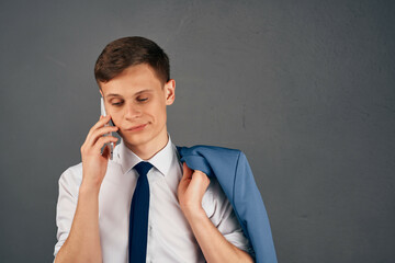 business man with a jacket on his shoulder talking on the phone office manager