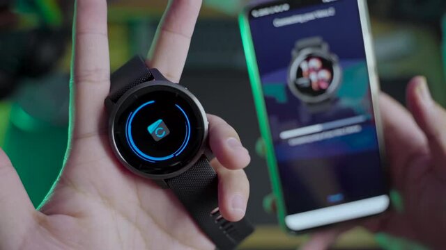 Modern lifestyle with smartwatch for fitness tracking. A men hand hold a fitnes smartwatch comparing with other smartwatch