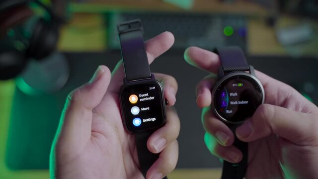 Modern lifestyle with smartwatch for fitness tracking. A men hand hold a fitnes smartwatch comparing with other smartwatch