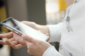 Movement motion of female hands using smart phone at the office, searching or social networks concept.