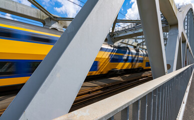 Steel railroad bridge with a passing train - 448527509